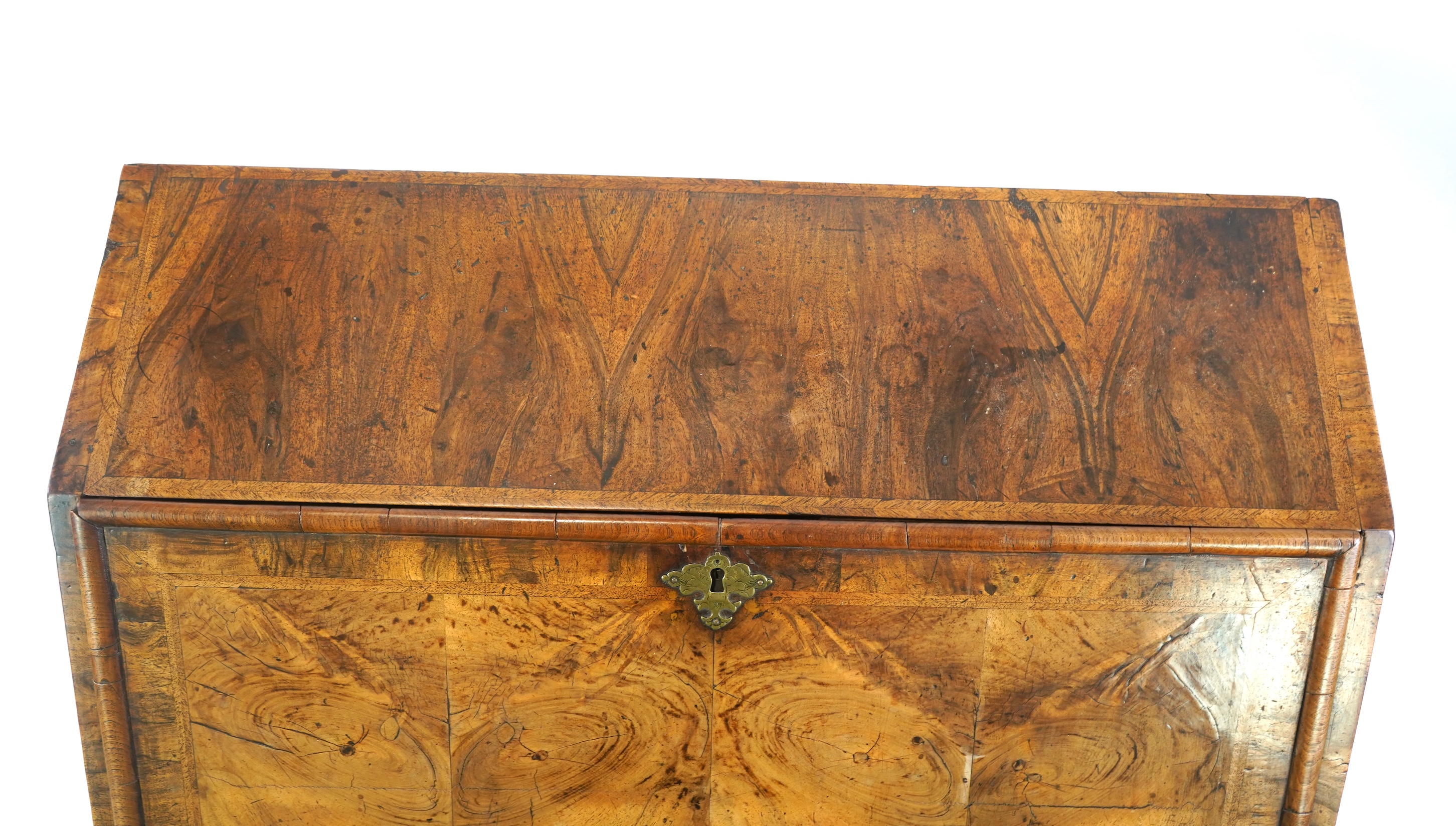 A George I feather banded walnut bureau